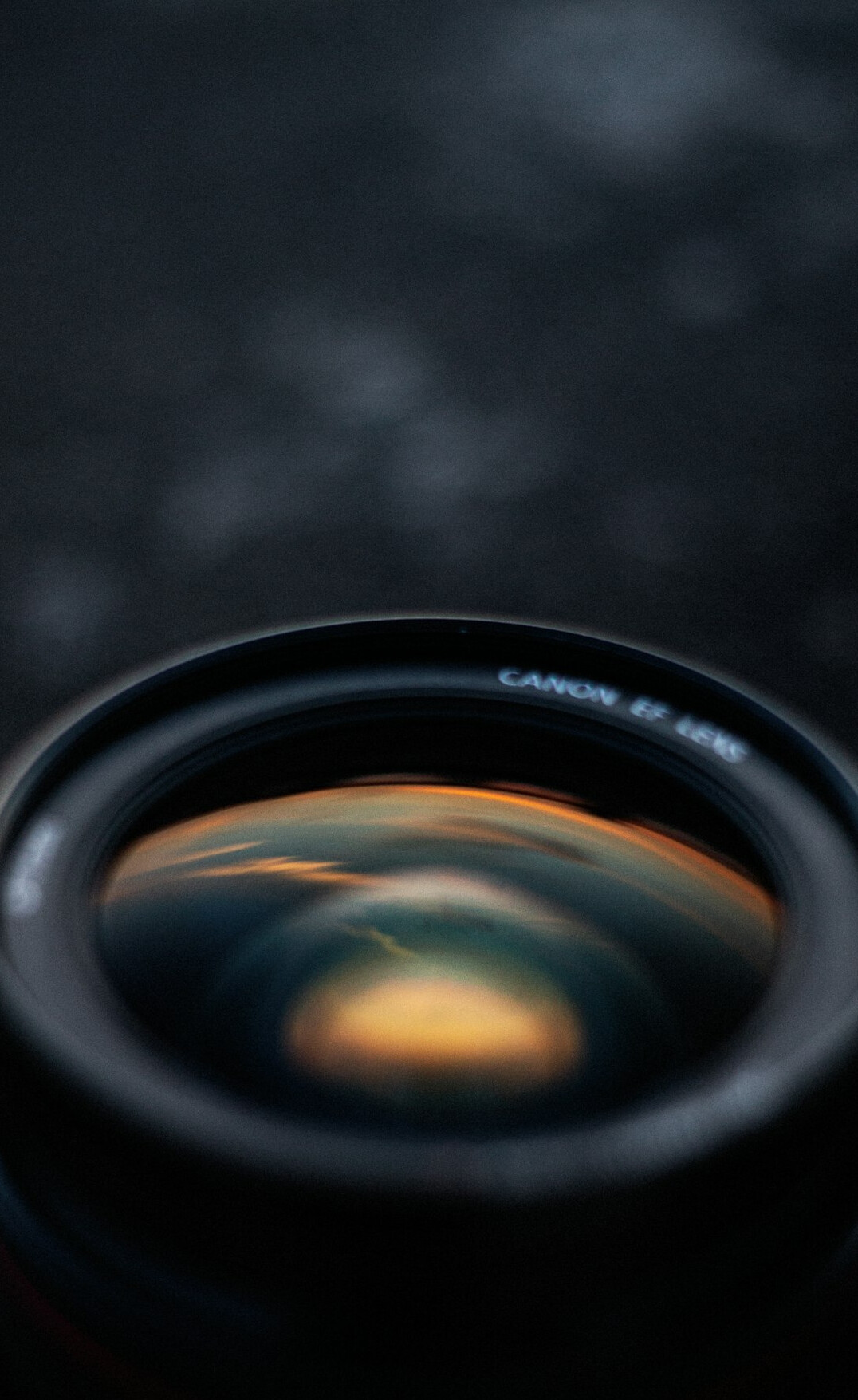 Camera lens close-up with warm reflections