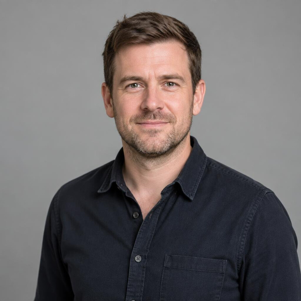 Portrait of a smiling bearded man in a casual shirt